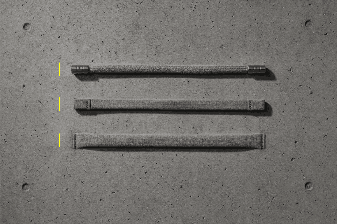 Three lengths of flat cotton drawcord laid in a row, one with metal stoppers, one with stitched-shut ends, one disappearing into a fabric channel