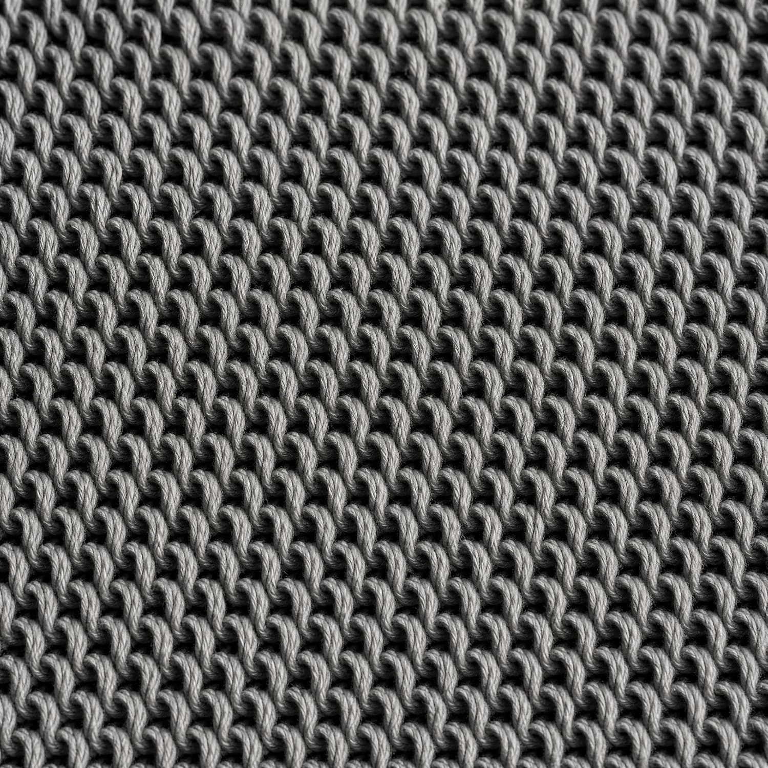 Macro of a loopback knit, showing regular rows of unbroken yarn loops